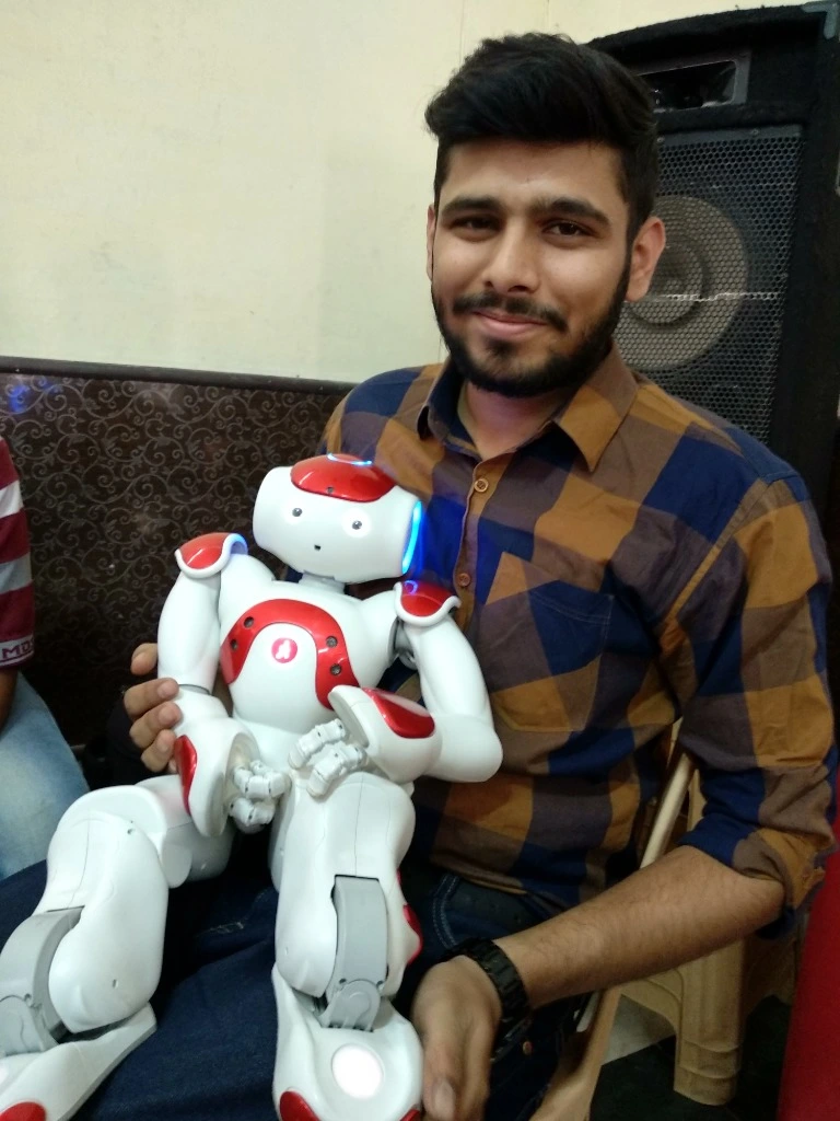 Ritwik Joshi working with a humanoid robot