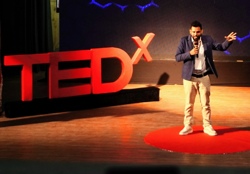 Ritwik Joshi speaking on the TEDx stage